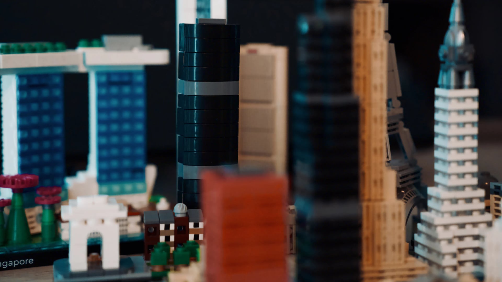 Wide view through a colourful LEGO city assembled from many architectural models.
