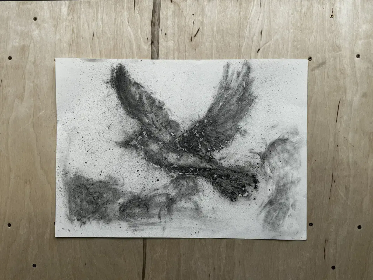 EN: Coal-and-ash bird drawing faded and flaked over time, leaving a ghostly silhouette on paper.