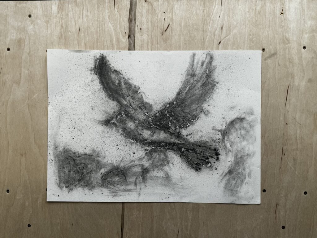 EN: Coal-and-ash bird drawing faded and flaked over time, leaving a ghostly silhouette on paper. CN: 煤炭与烟灰绘制的飞鸟,随时间褪色、剥落,只剩下幽灵般的轮廓。
