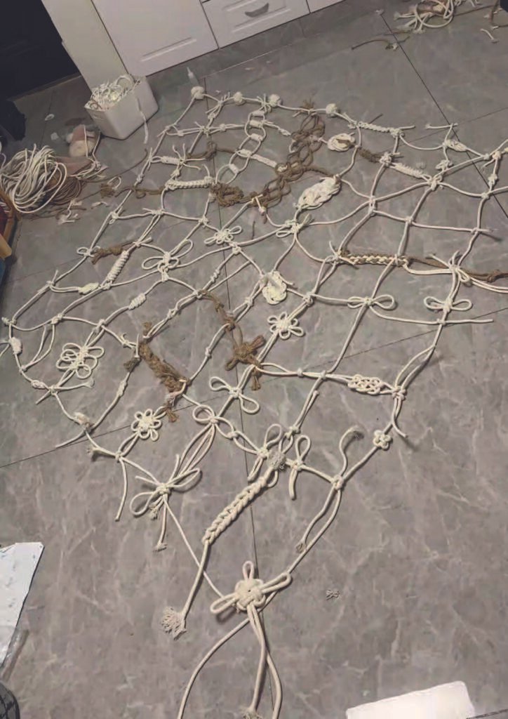 Cotton and jute ropes spread across the studio floor, gradually forming a loose, irregular web.